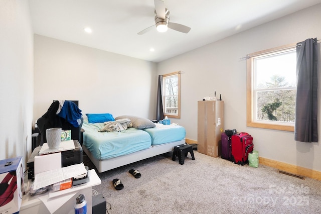 carpeted bedroom with a ceiling fan, recessed lighting, visible vents, and baseboards