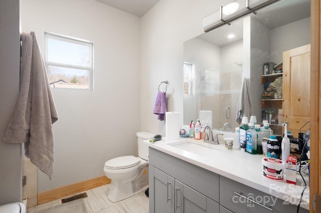 bathroom with visible vents, baseboards, toilet, vanity, and a shower stall