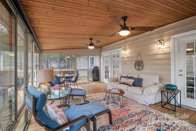 sunroom / solarium featuring lofted ceiling, wood ceiling, and a ceiling fan