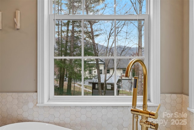 interior details featuring a wainscoted wall