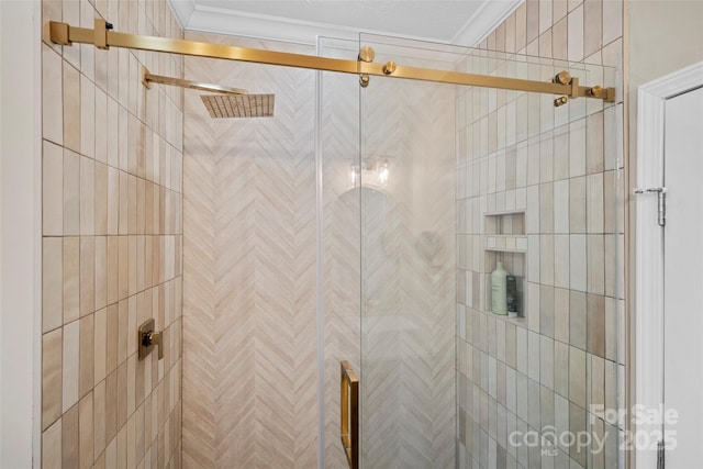 full bath featuring a stall shower and ornamental molding