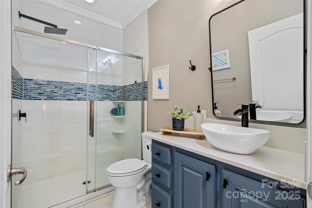 bathroom featuring toilet, a stall shower, crown molding, and vanity