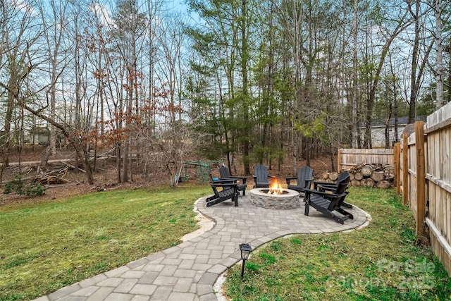 view of yard with a patio, an outdoor fire pit, and fence