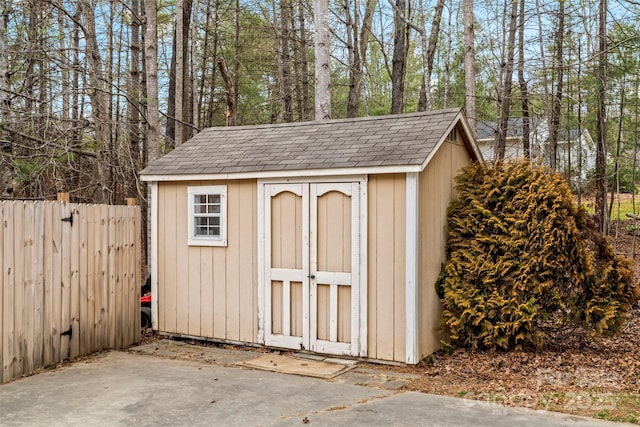 view of shed featuring fence