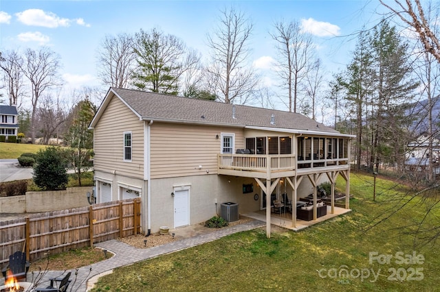 back of house with central AC unit, fence, a sunroom, a lawn, and a patio area