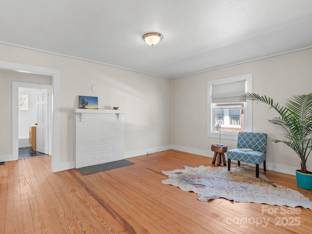 living area featuring hardwood / wood-style flooring and baseboards