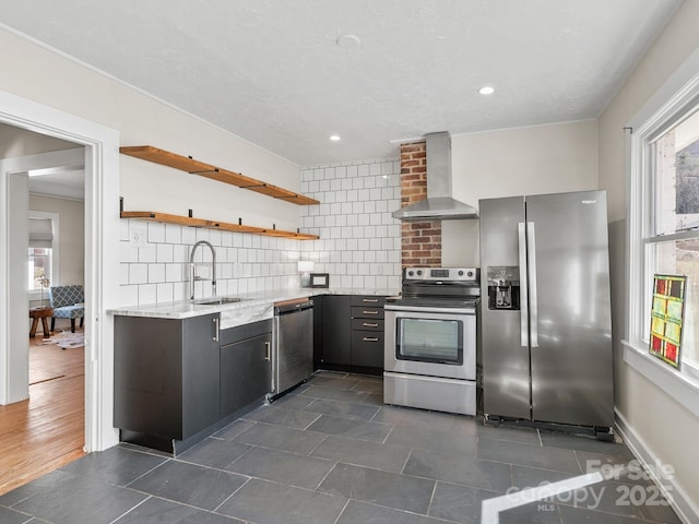 kitchen with open shelves, a sink, decorative backsplash, stainless steel appliances, and wall chimney range hood