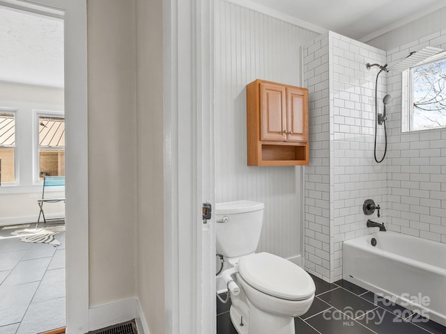 full bathroom featuring tile patterned flooring, shower / bathing tub combination, toilet, and baseboards