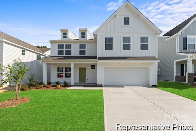 view of front of home with a garage, driveway, a front lawn, and board and batten siding