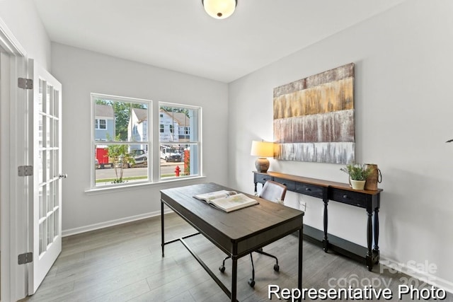 office area featuring baseboards and wood finished floors