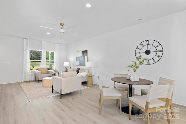 living area with recessed lighting, visible vents, light wood-style flooring, and baseboards