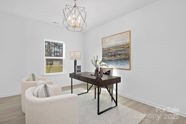 office space featuring light wood-style flooring, visible vents, baseboards, and a chandelier