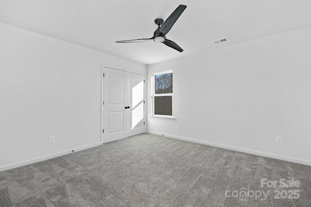 empty room featuring baseboards, visible vents, ceiling fan, and carpet flooring