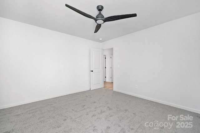 unfurnished room featuring baseboards, a ceiling fan, and carpet flooring