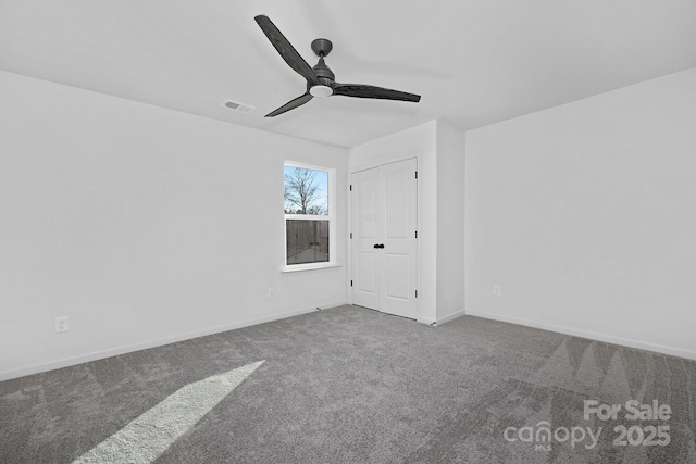 interior space featuring a ceiling fan, visible vents, baseboards, and carpet flooring