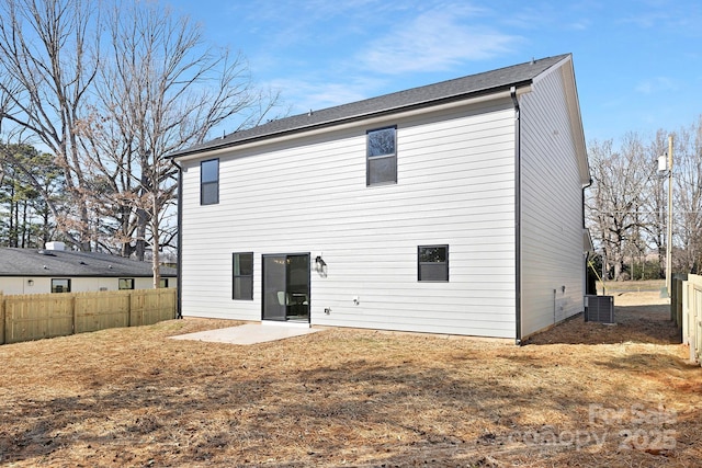 back of property featuring central air condition unit, fence, and a patio