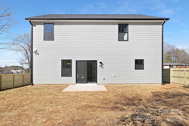 rear view of property with a patio, a lawn, and a fenced backyard