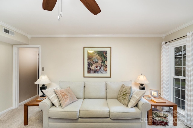 carpeted living area featuring visible vents, baseboards, ornamental molding, and a ceiling fan