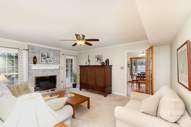 living area with baseboards, ceiling fan, ornamental molding, light carpet, and a brick fireplace