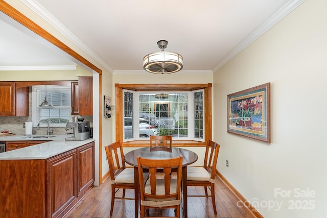 dining area featuring plenty of natural light, baseboards, and hardwood / wood-style floors