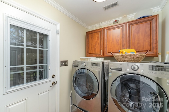 washroom featuring visible vents, cabinet space, separate washer and dryer, and ornamental molding