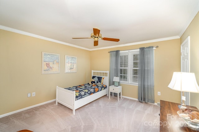 carpeted bedroom featuring a ceiling fan, baseboards, and ornamental molding