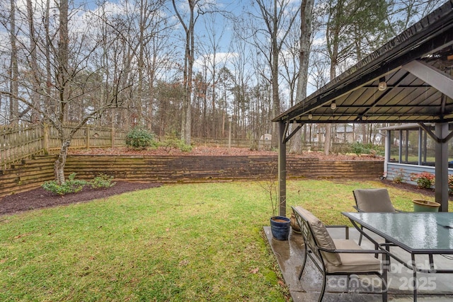 view of yard with outdoor dining space and fence