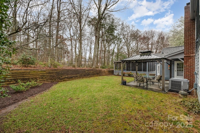 view of yard with a gazebo, central air condition unit, and a patio