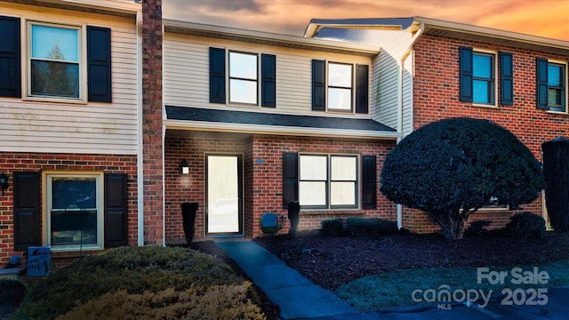 view of property with brick siding