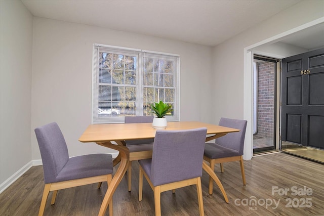 dining area with wood finished floors and baseboards