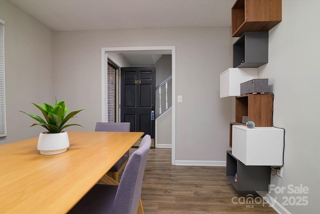 dining room featuring stairs, dark wood finished floors, and baseboards