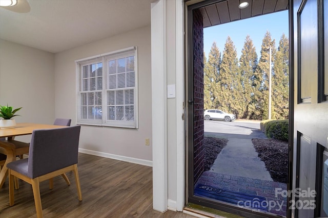 dining room featuring wood finished floors and baseboards