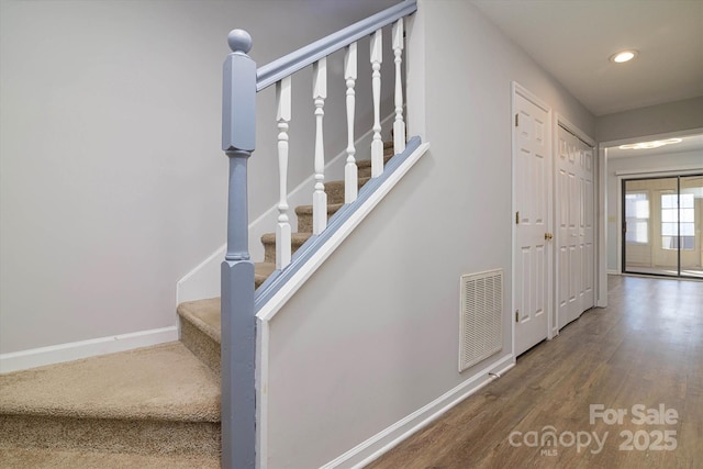 stairs featuring baseboards, visible vents, wood finished floors, and recessed lighting