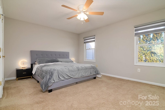 bedroom with baseboards, a ceiling fan, and light colored carpet