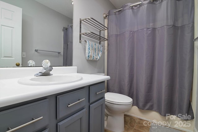 full bathroom featuring toilet, tile patterned flooring, vanity, and shower / bathtub combination with curtain