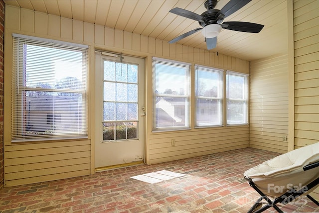 unfurnished sunroom featuring a ceiling fan and wood ceiling