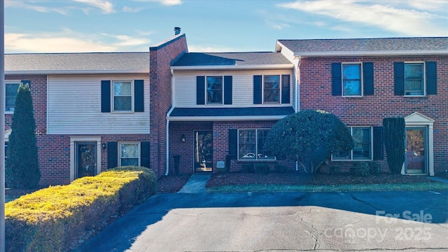 view of property with brick siding