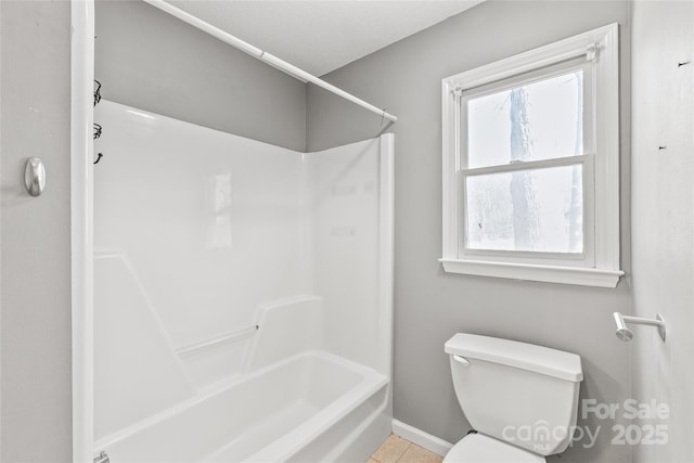 full bathroom featuring baseboards, bathtub / shower combination, toilet, and tile patterned floors