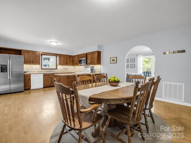 232 Stonebrook Dr, Hendersonville, NC 28791 - dining area featuring light wood-style floors and arched walkways