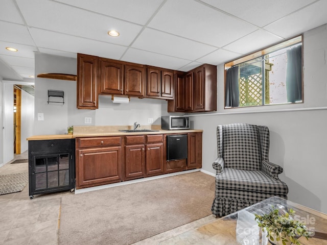 232 Stonebrook Dr, Hendersonville, NC 28791 - kitchen featuring stainless steel microwave, a sink, light countertops, a drop ceiling, and baseboards
