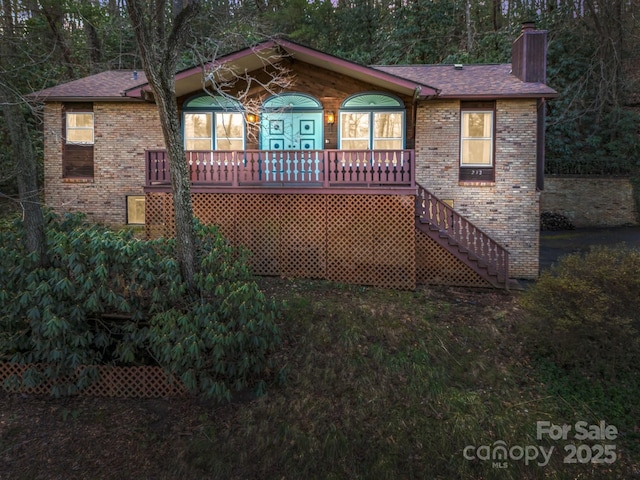 232 Stonebrook Dr, Hendersonville, NC 28791 - ranch-style home featuring a chimney, brick siding, stairs, and covered porch