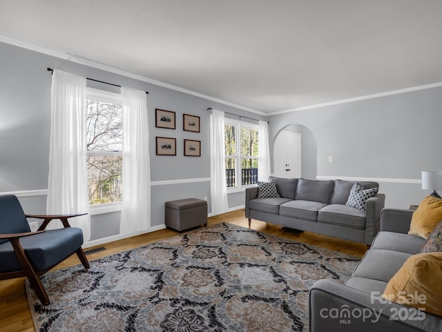 232 Stonebrook Dr, Hendersonville, NC 28791 - living room featuring arched walkways, crown molding, wood finished floors, and baseboards