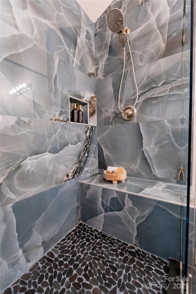 details featuring a marble finish shower