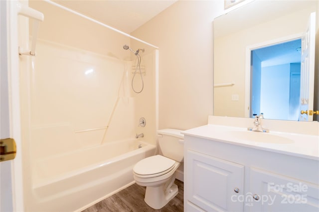 full bathroom featuring toilet, shower / bath combination, wood finished floors, and vanity