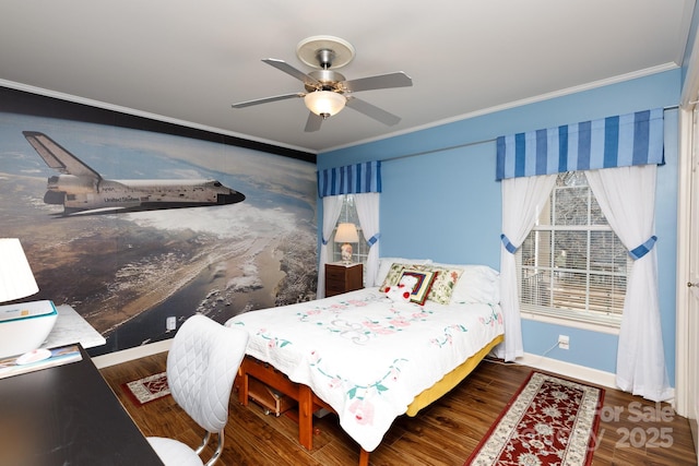 bedroom featuring ornamental molding, wood finished floors, a ceiling fan, and baseboards