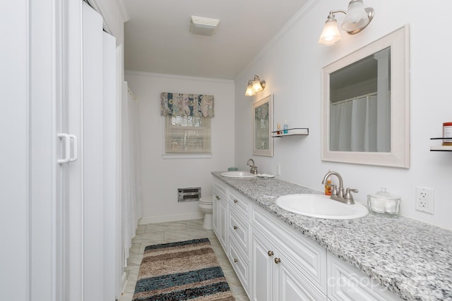 full bathroom with double vanity, ornamental molding, toilet, and a sink