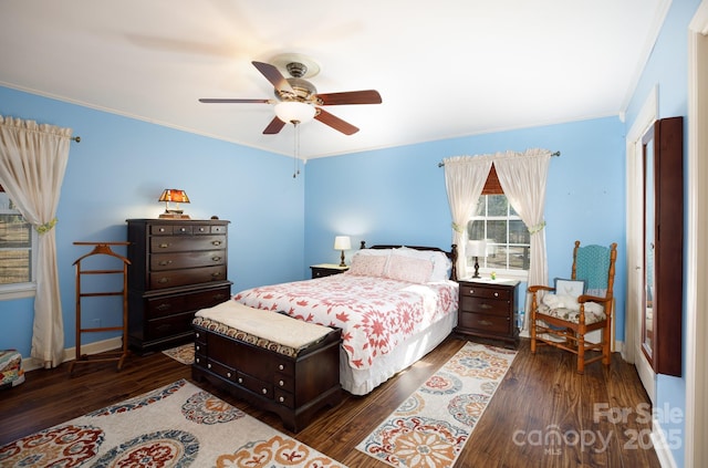 bedroom with crown molding, baseboards, and wood finished floors