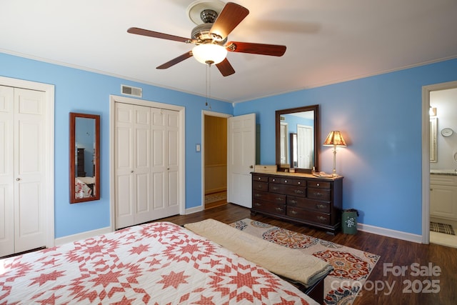 bedroom with baseboards, ornamental molding, visible vents, and multiple closets