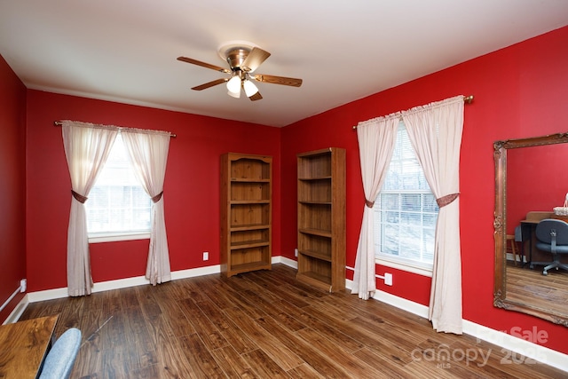 interior space featuring a ceiling fan, baseboards, and wood finished floors