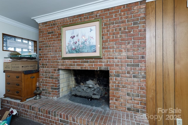 details featuring ornamental molding and a brick fireplace